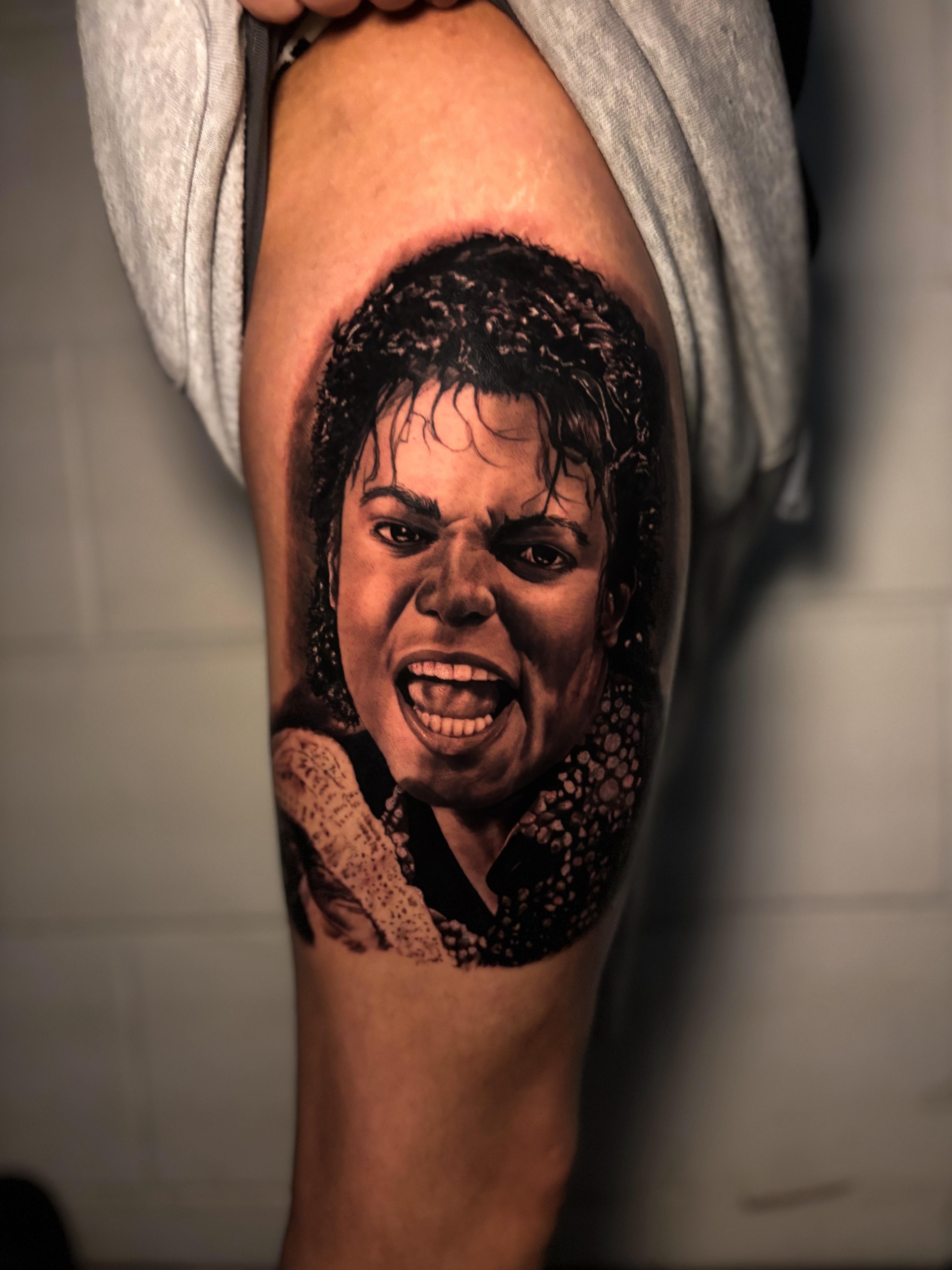 Realistic Michael Jackson portrait tattoo