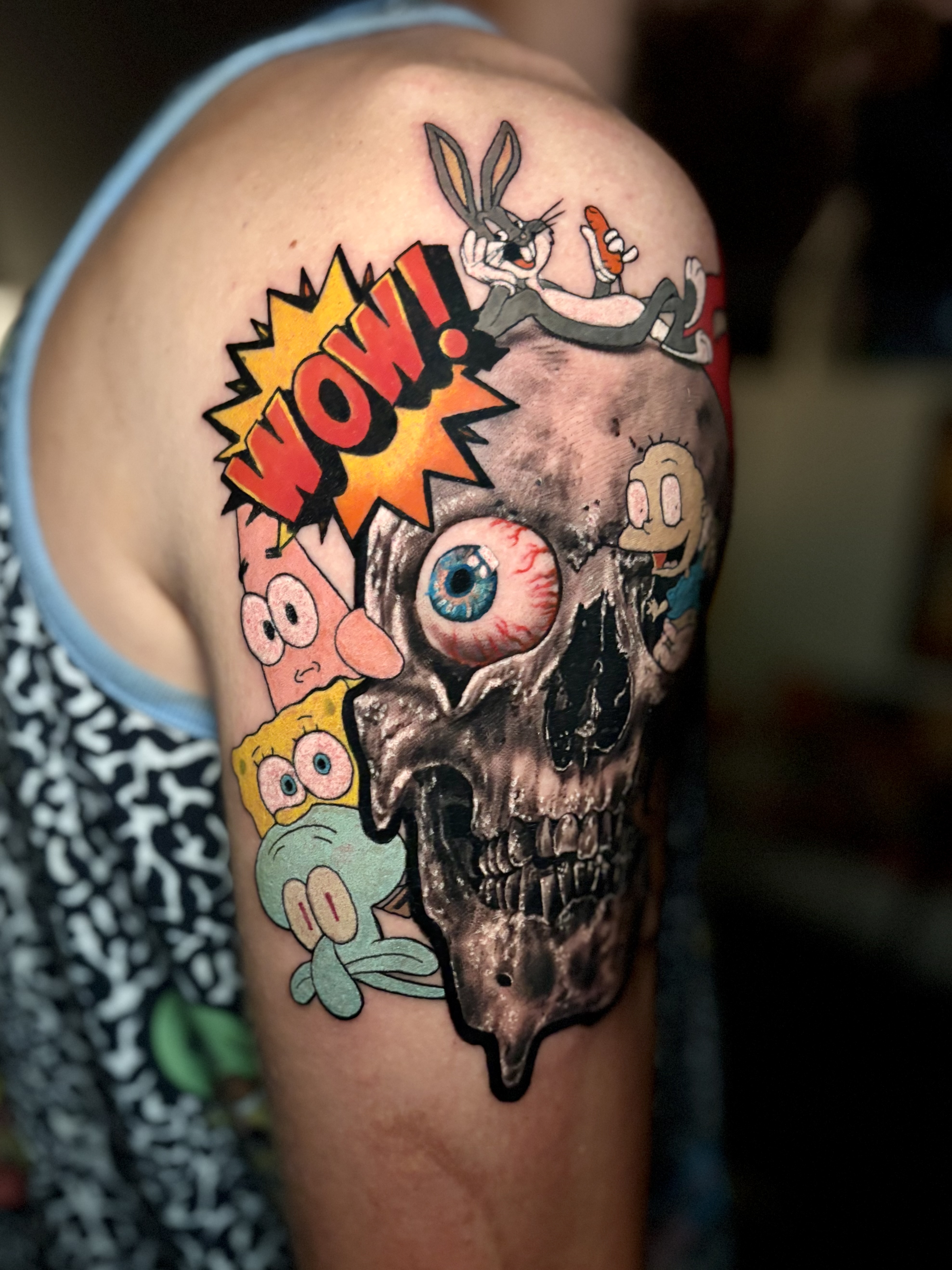 Cartoon characters and melting skull mashup tattoo
